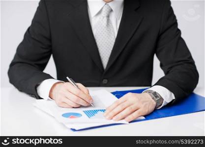 picture of businessman working and signing papers