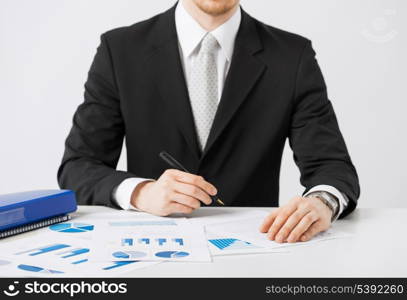 picture of businessman working and signing with papers