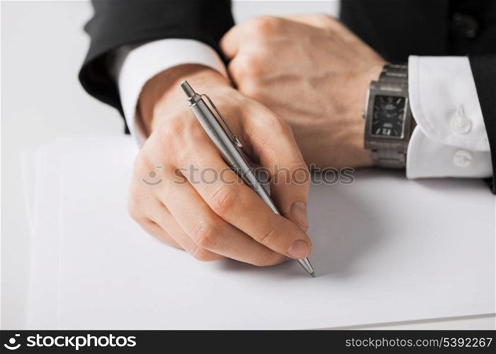 picture of businessman writing something on the paper
