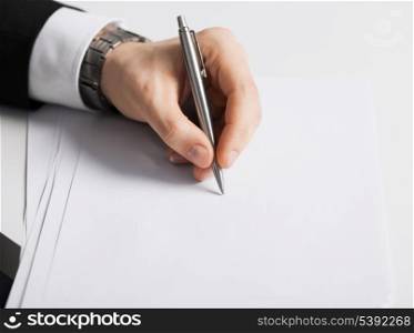 picture of businessman writing something on the paper
