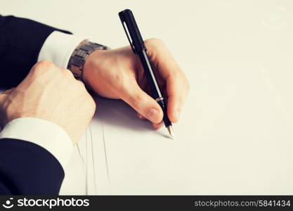 picture of businessman writing something on the paper