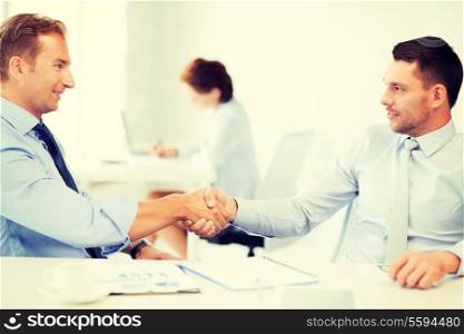 picture of businessmen shaking hands in office