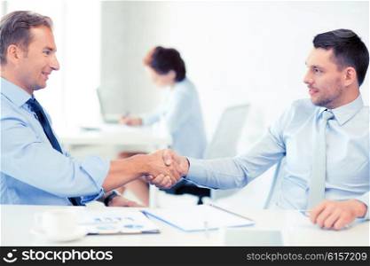 picture of businessmen shaking hands in office. businessmen shaking hands in office