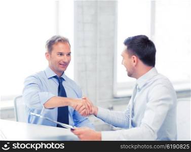 picture of businessmen shaking hands in office. businessmen shaking hands in office
