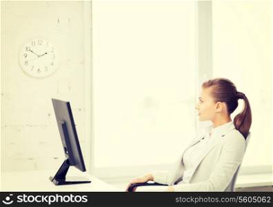 picture of businesswoman looking at wall clock in office