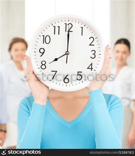 picture of businesswoman with clock over her face in office