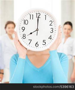 picture of businesswoman with clock over her face in office