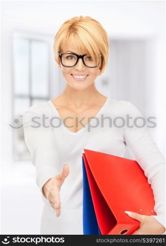 picture of businesswoman with folders ready for handshake