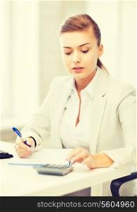 picture of businesswoman with notebook and calculator