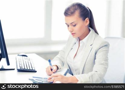 picture of businesswoman with notebook and calculator. businesswoman with notebook and calculator