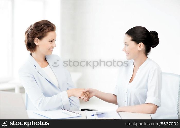 picture of businesswomen shaking hands in office