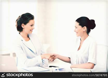 picture of businesswomen shaking hands in office
