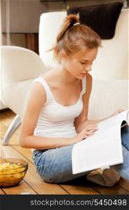 picture of calm and serious teenage girl with magazine.