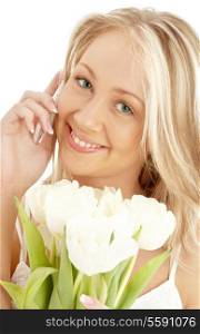picture of cheerful blond with white tulips and phone