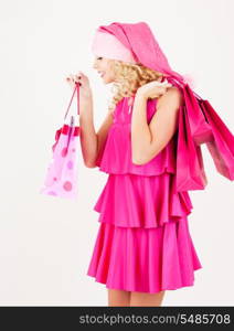 picture of cheerful santa helper girl with shopping bags