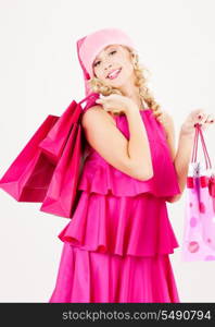 picture of cheerful santa helper girl with shopping bags