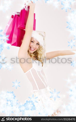 picture of cheerful santa helper girl with shopping bags