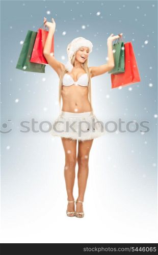 picture of cheerful santa helper with shopping bags.