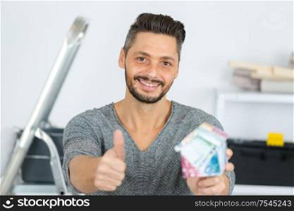 picture of cheerful young man showing thumbs up