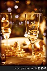 Picture of Christmas table setting, retro style photo, glasses for champagne, golden Christmastime decorations, white festive dishware, soft focus, New Year dinner, xmas eve, luxury home interior