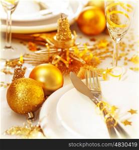 Picture of Christmas table setting still life, festive white utensil decorated with golden candle and shiny xmas tree ball toys, romantic holiday dinner, New Year party, luxury table decorations