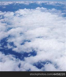 Picture of cloudy sky, type of the sky from flight height, white clouds on blue sky, blue natural background, peaceful heaven, cumulonimbus landscape, aerial scenery, bright sunshine