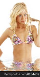 picture of colorful bikini blonde standing in water