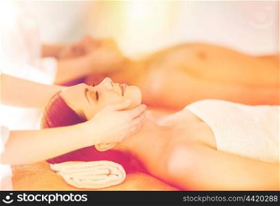 picture of couple in spa salon getting face treatment. couple in spa