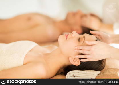 picture of couple in spa salon getting face treatment. couple in spa