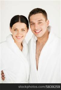 picture of couple in spa salon in white bathrobes. couple in spa
