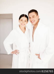 picture of couple in spa salon in white bathrobes. couple in spa