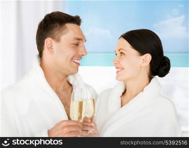 picture of couple in spa salon in white bathrobes with champagne
