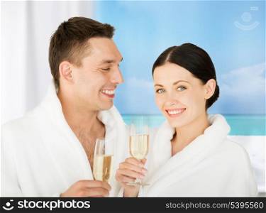 picture of couple in spa salon in white bathrobes with champagne