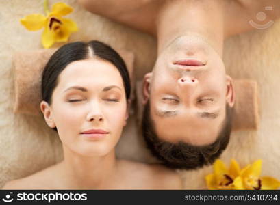 picture of couple in spa salon lying on the massage desks