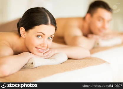 picture of couple in spa salon lying on the massage desks