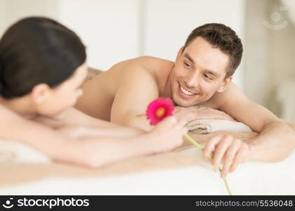 picture of couple in spa salon lying on the massage desks