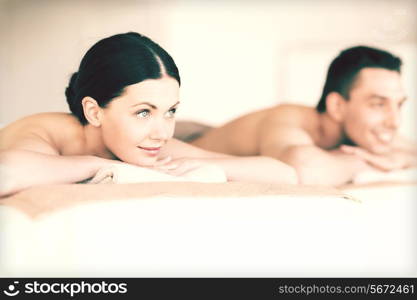 picture of couple in spa salon lying on the massage desks