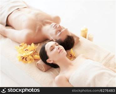 picture of couple in spa salon lying on the massage desks