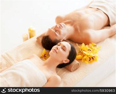 picture of couple in spa salon lying on the massage desks. couple in spa
