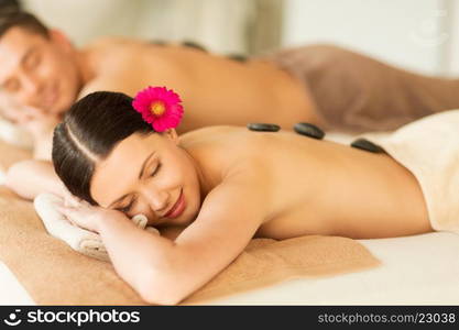 picture of couple in spa salon with hot stones. couple in spa with hot stones