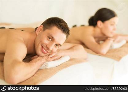 picture of couple in spa salon with hot stones. couple in spa with hot stones