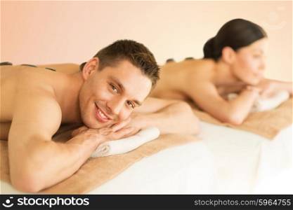 picture of couple in spa salon with hot stones. couple in spa with hot stones