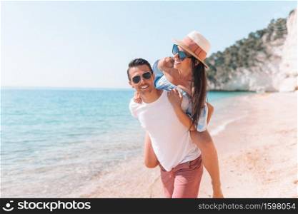 Picture of couple on white beach having fun. Happy family enjoy their honeymoon on the seashore. picture of happy couple in sunglasses on the beach