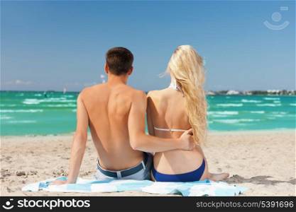 picture of couple sitting on the beach