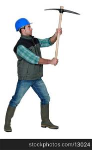 picture of craftsman holding pickaxe in profile