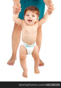 Picture of cute baby boy making his first step, naked infant in diaper holding mother&rsquo;s hands, adorable pretty toddler isolated on white background, mother supported son to make great achievement