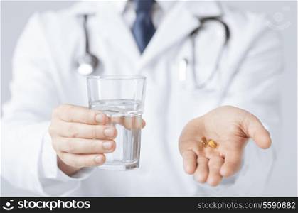 picture of doctor hands giving capsule and glass of water