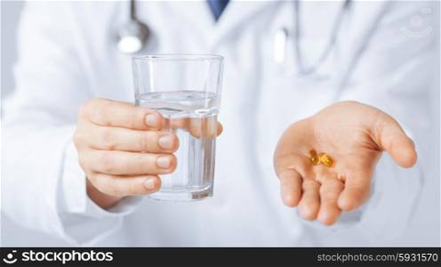 picture of doctor hands giving capsule and glass of water. doctor hands giving capsule and glass of water