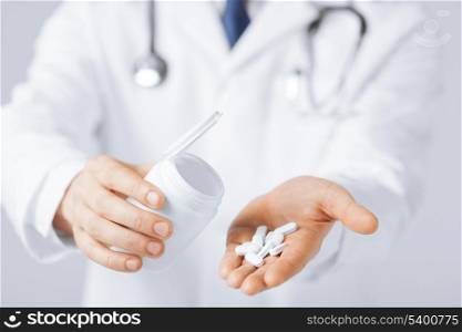 picture of doctor hands holding white pack and pills