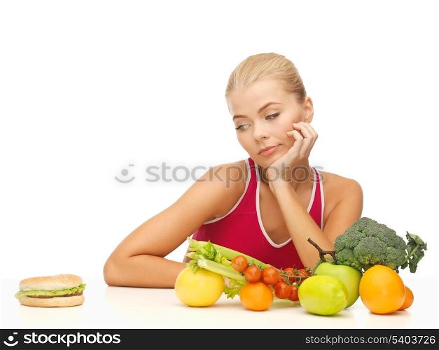picture of doubting woman with fruits and hamburger